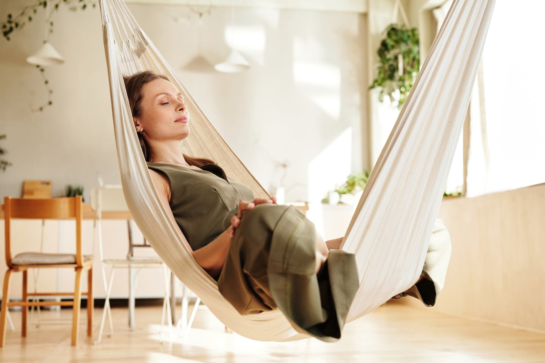 photo of a woman closing her eyes on a hammock